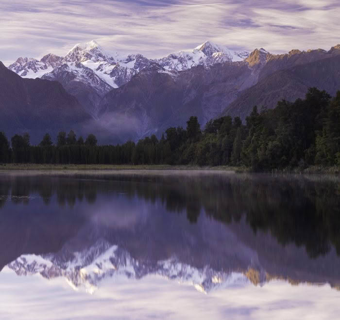 Lake Matheson at dawn with Mount Cook and the Southern Alps reflected